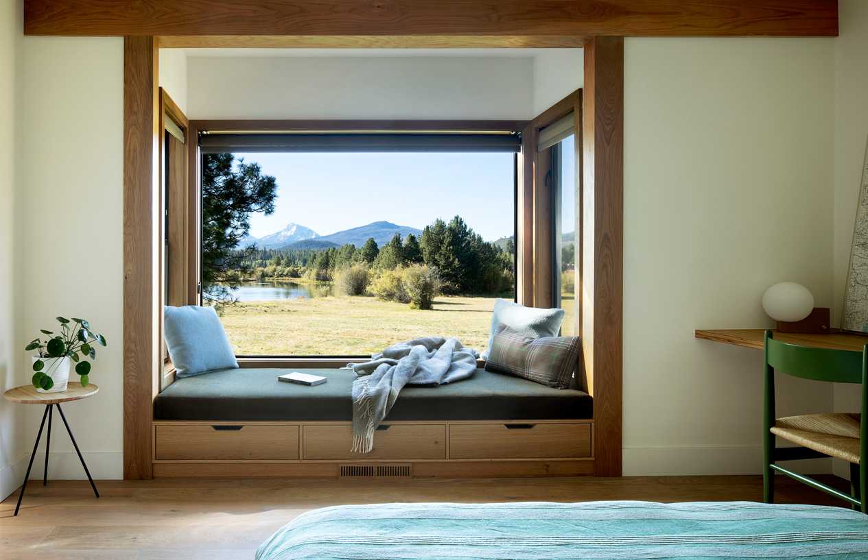 Bedroom window overlooking the mountains and a pond